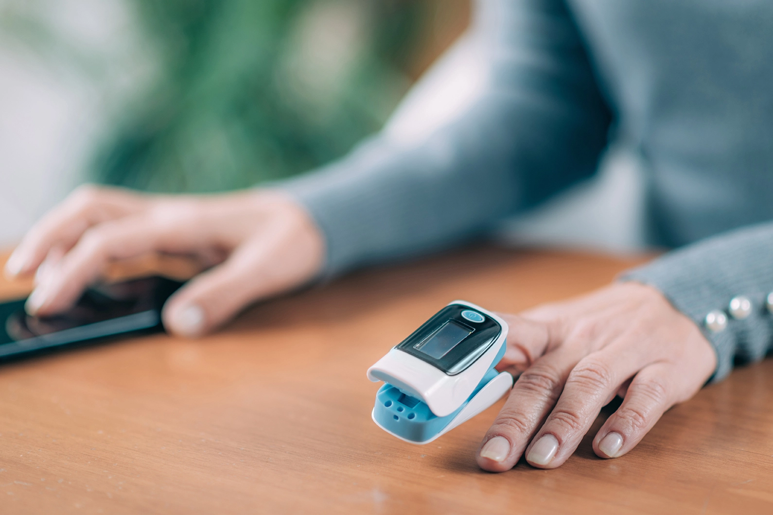 A person wearing a fingertip pulse oximetter