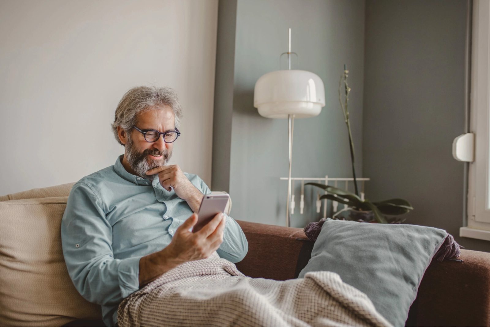 Man on sofa with smartphone