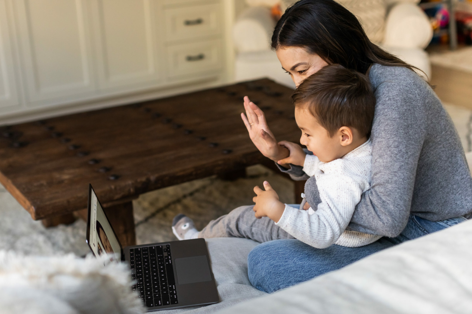 Mother and toddler aged son in telemedicine call