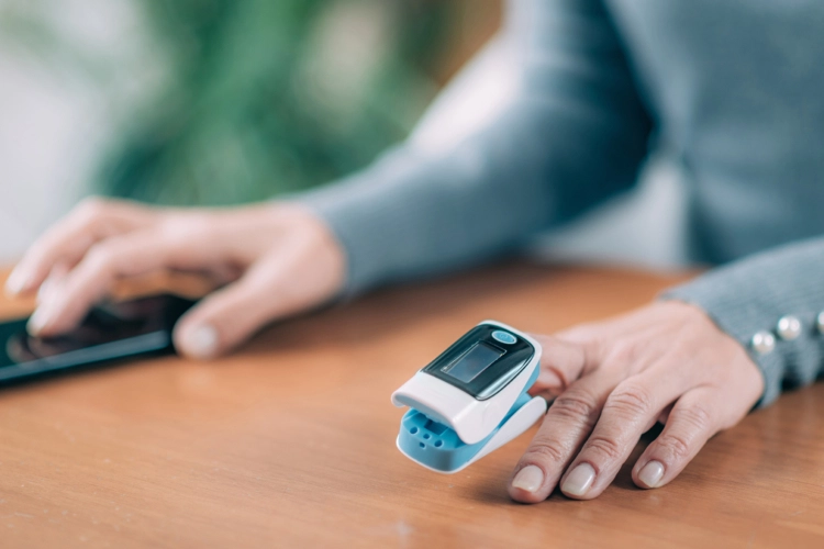 A person wearing a fingertip pulse oximetter