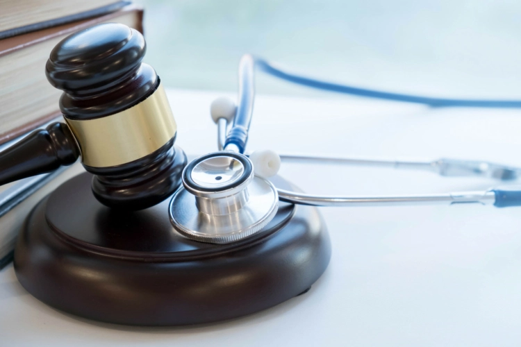 A stethoscope sitting next to a gavel
