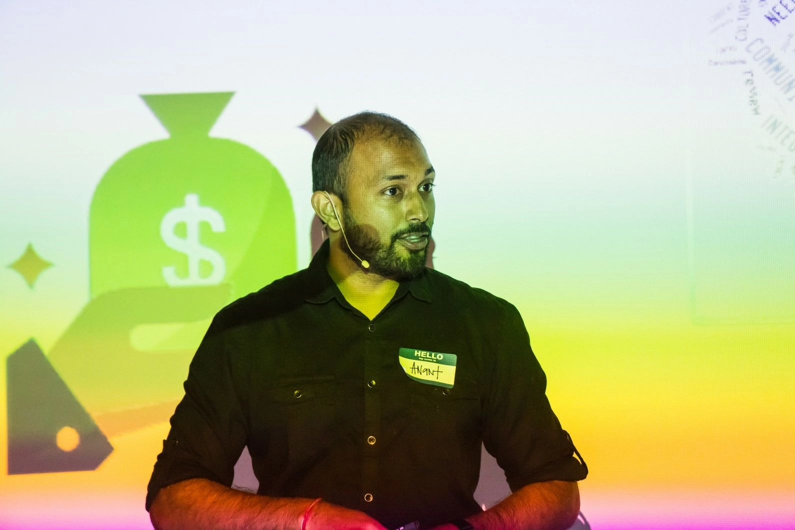 A man presenting on stage at a conference