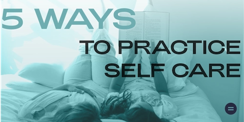 Two people laying on bed talking