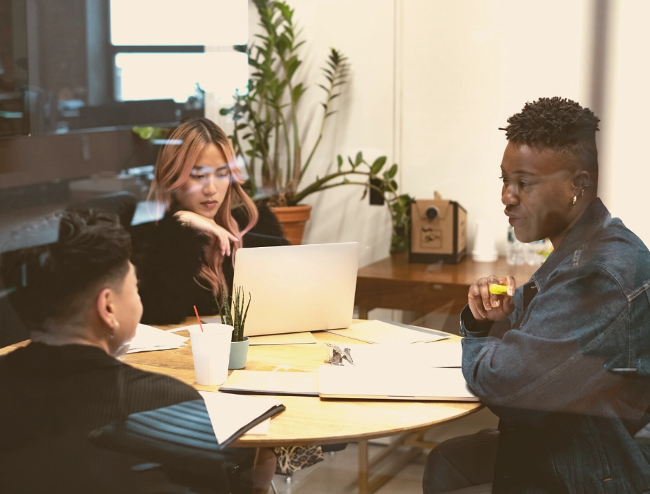 lgbtq group sitting at table at work