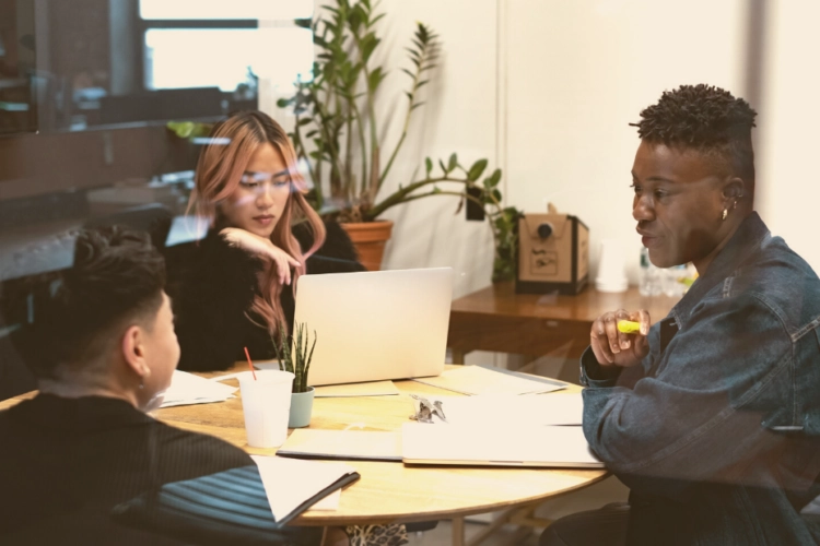 lgbtq group sitting at table at work