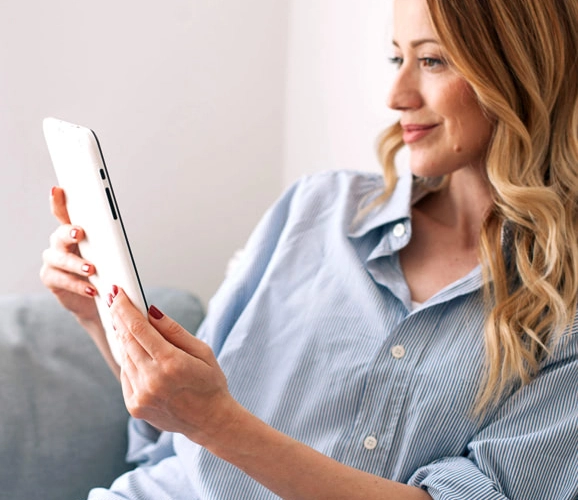 Woman on sofa with tablet