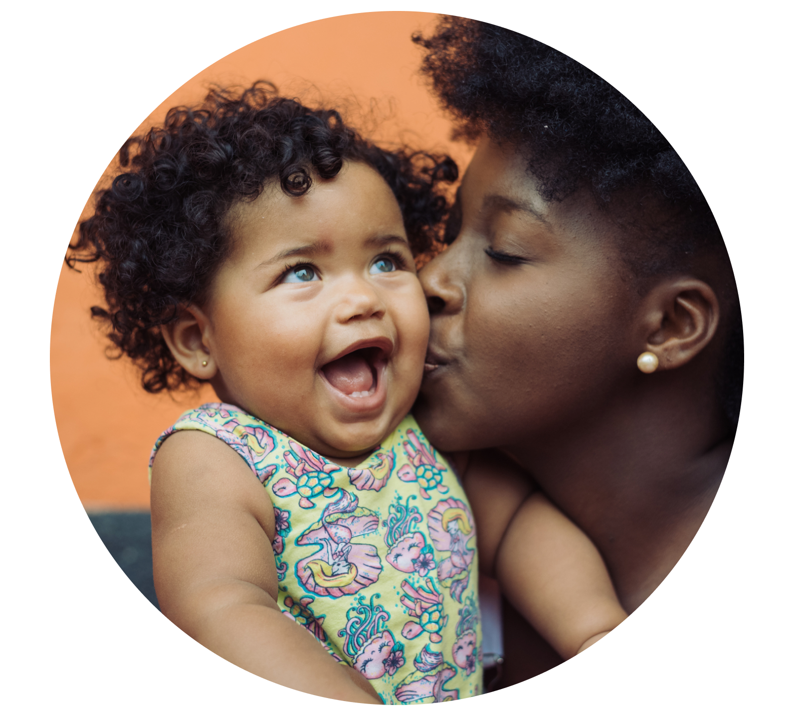 mom kissing baby on cheek
