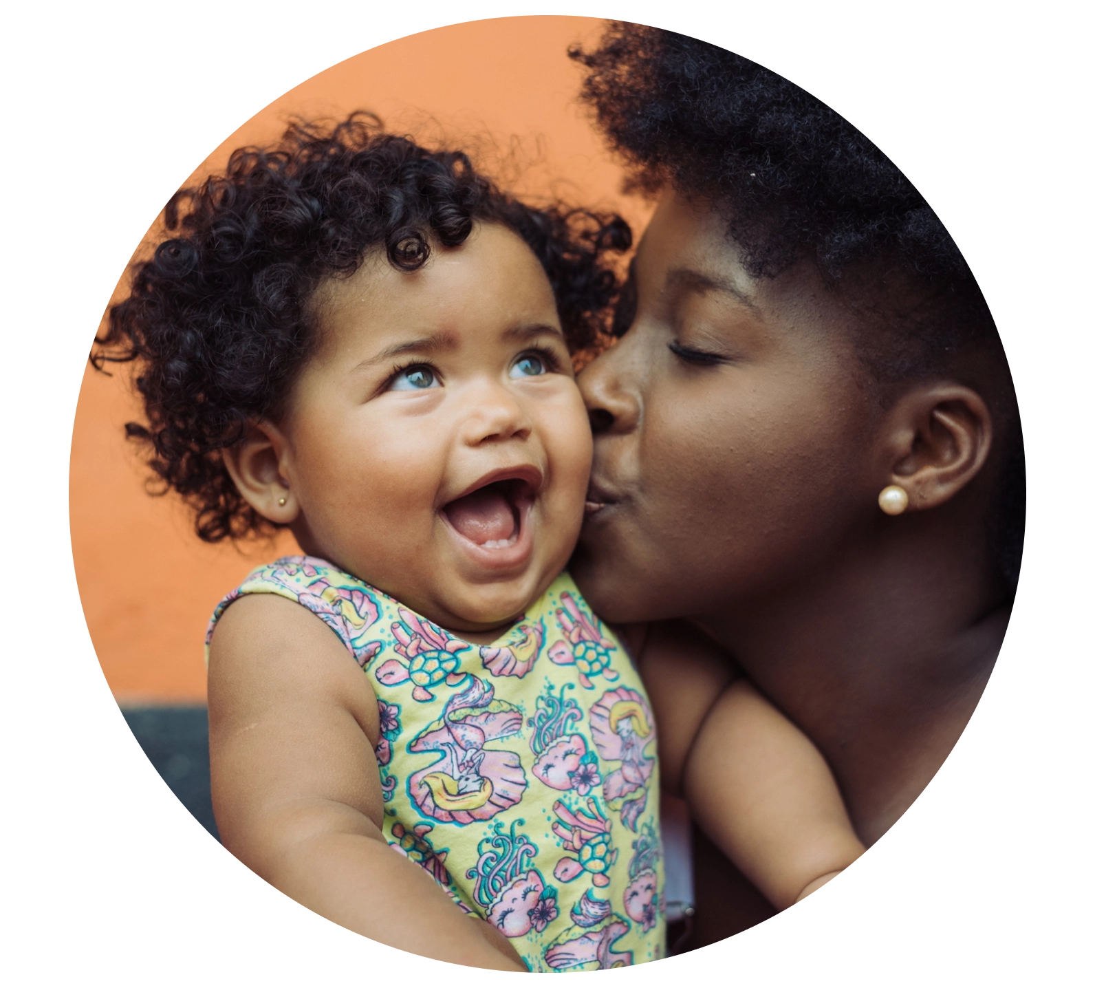 mom kissing baby on cheek