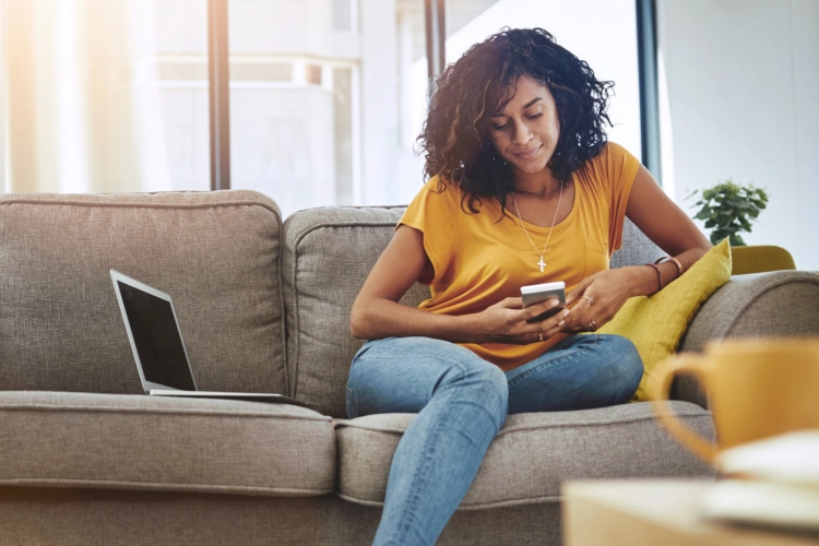 woman on phone sitting on couch