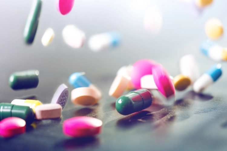 multi-colored pills spilling on table