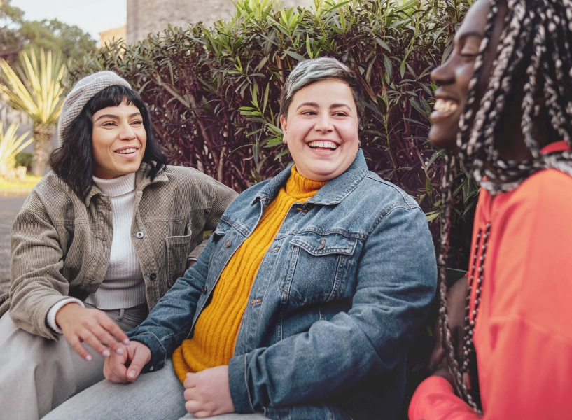 3 friends laughing outside