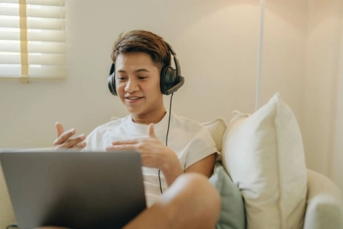 person with headphones on computer