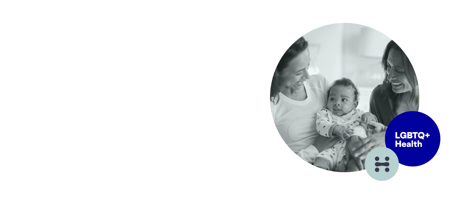 2 women holding a baby all smiling