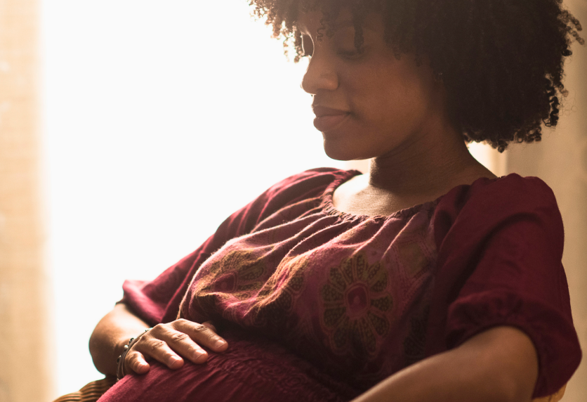 pregnant woman holding her stomach