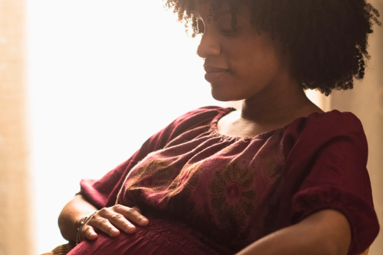 pregnant woman holding her stomach