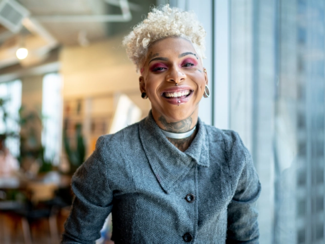 smiling nonbinary LGBTQ+ employee