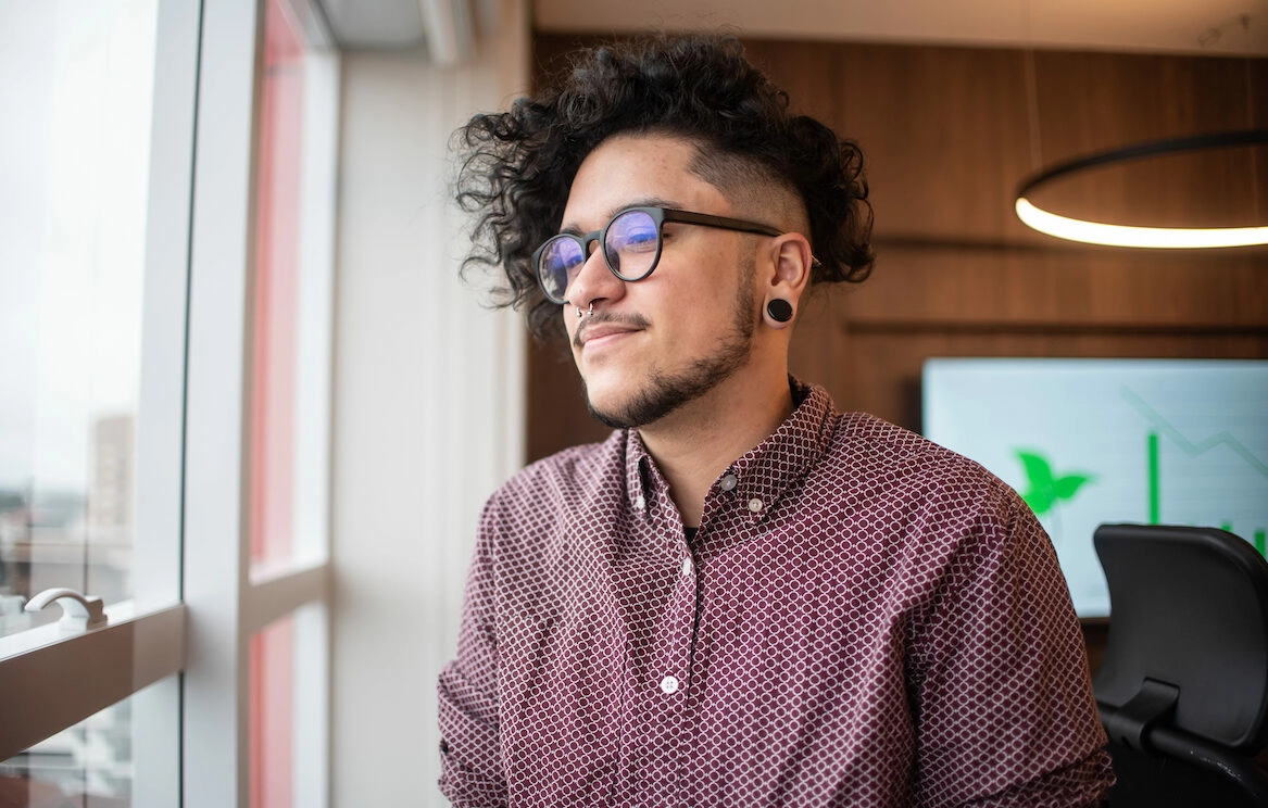 lgbtq member looking out the window