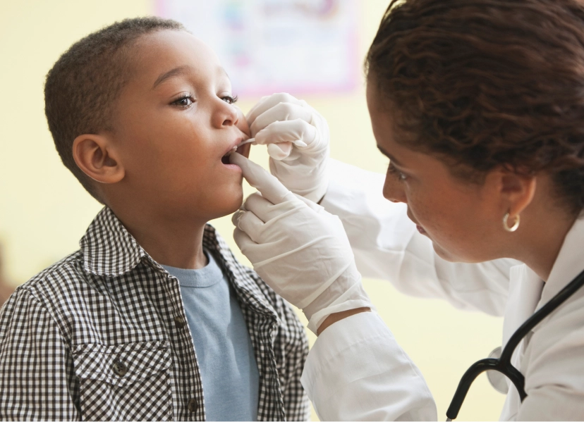 Doctor looking into child's throat