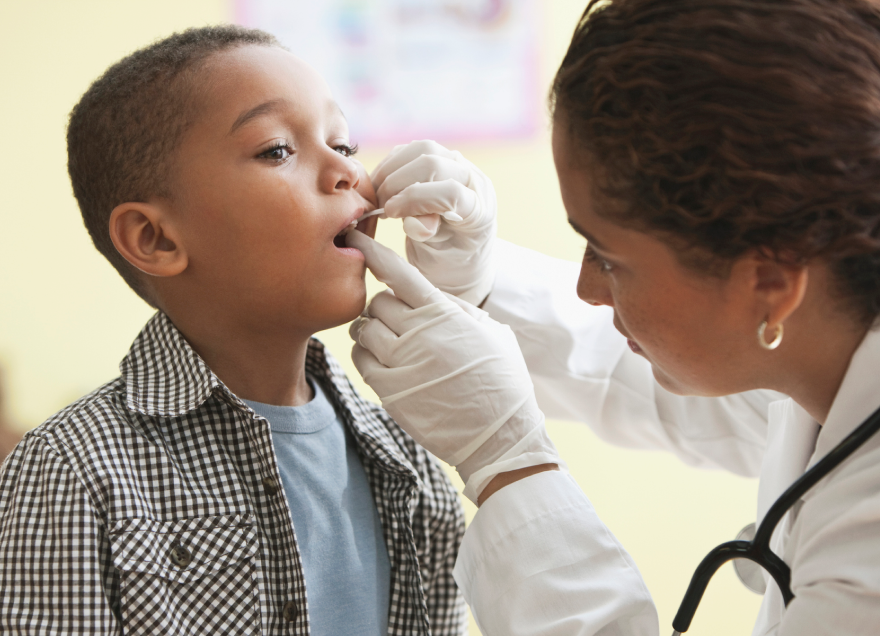 Doctor looking at boys teeth