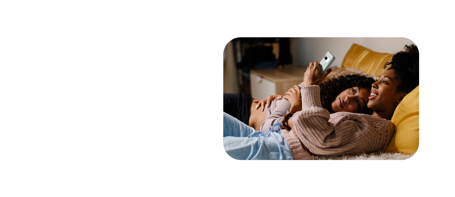 Two woman in bed with smartphone