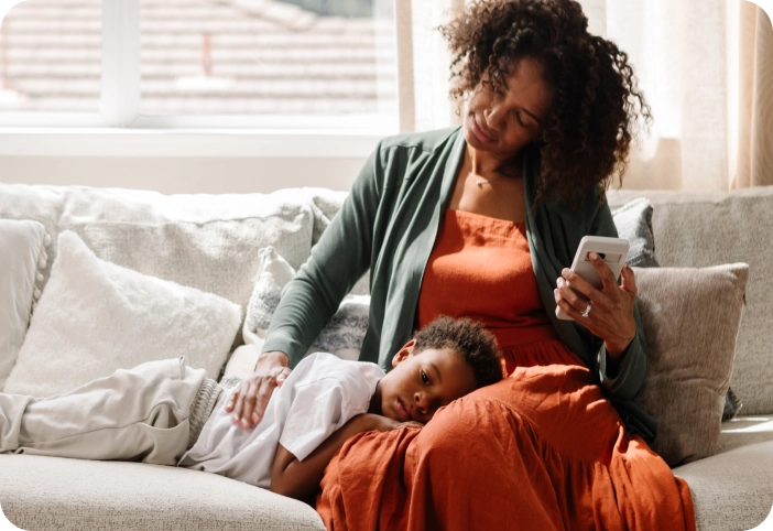 mom with sick child on couch