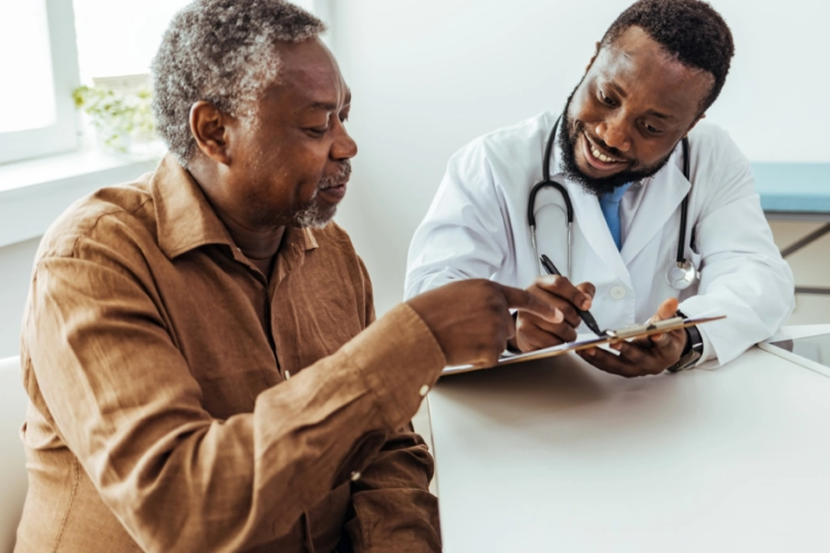 man reviewing his chart with doctor