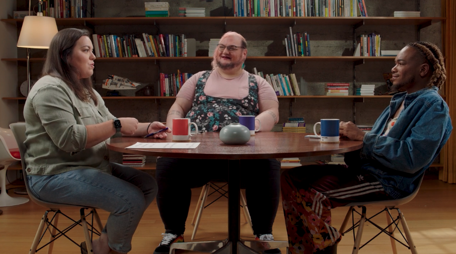 LGBTQ+ Care Coordinators at Included Health discussing their experience sitting at a table