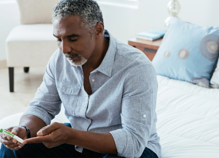 Black adult checking glucose
