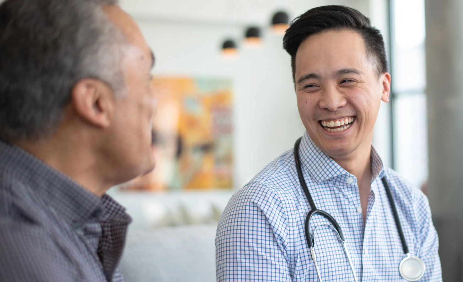 A smiling doctor speaks with a patient