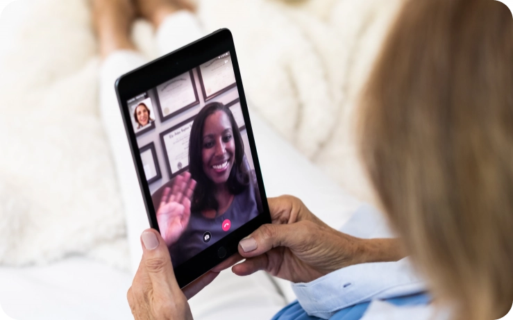 An online doctor speaks to a patient through a tablet