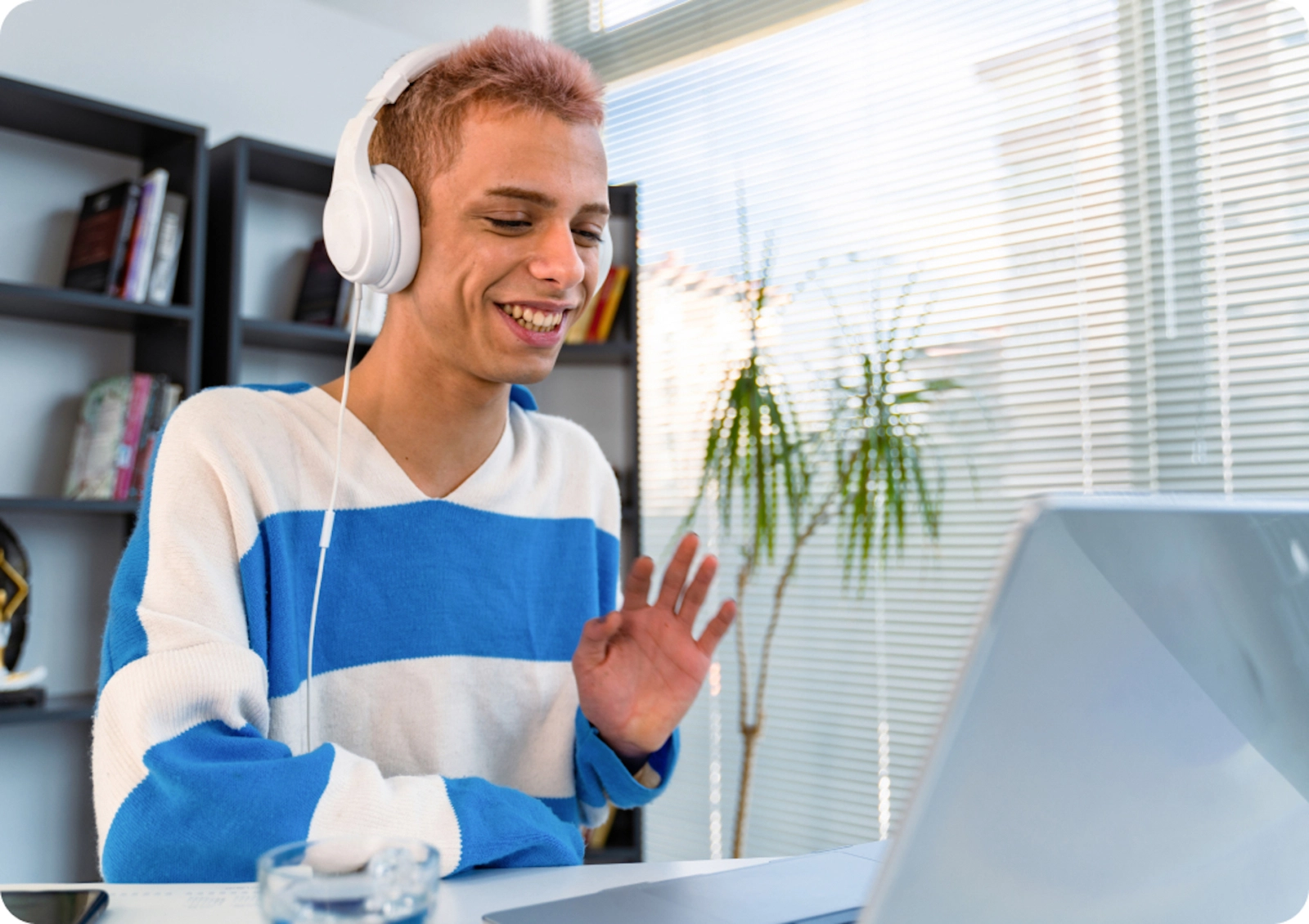 An LGBTQ+ Care Coordinator sits in their office speaking with a member