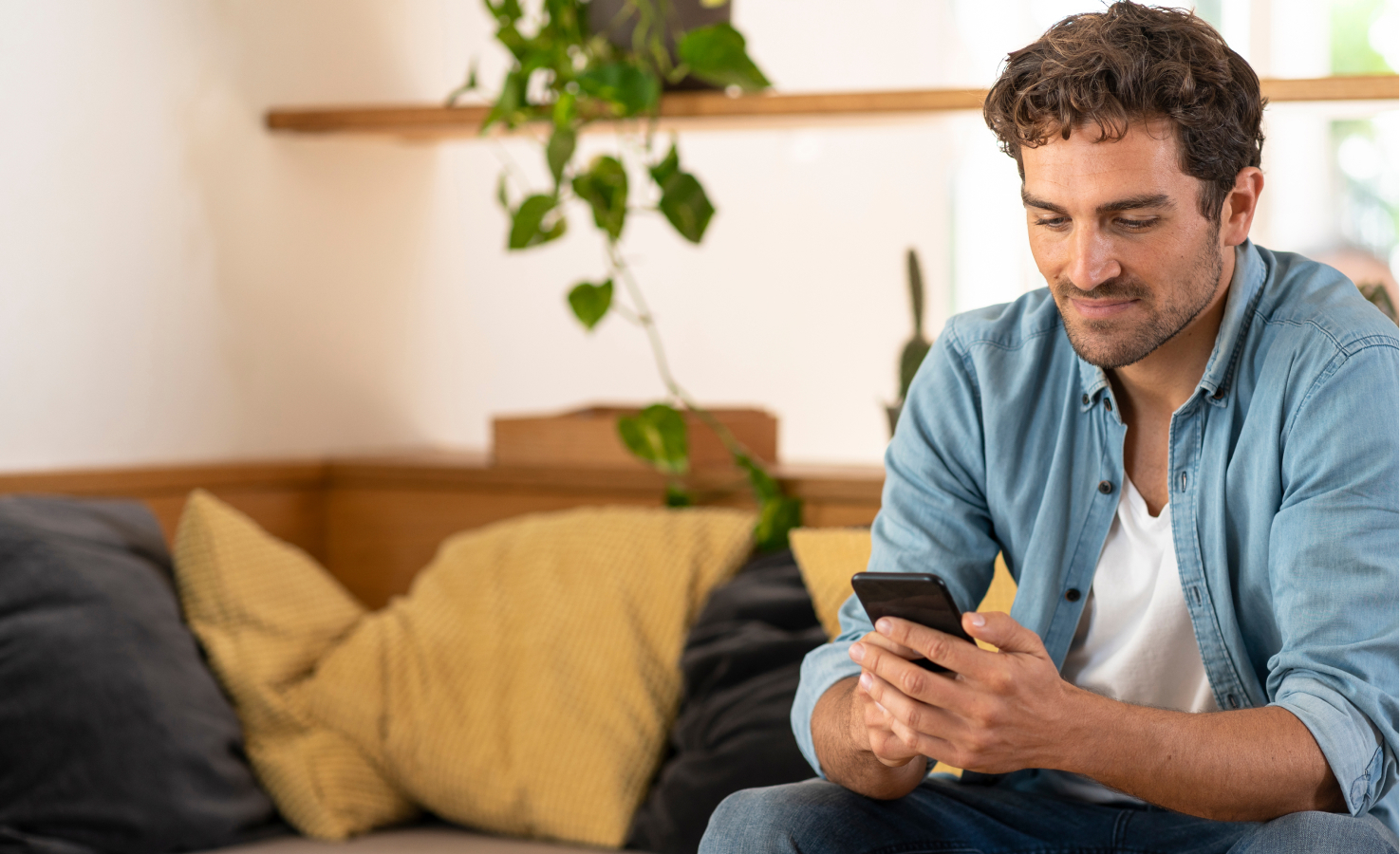 A young man searches for an in-network pharmacy on his phone