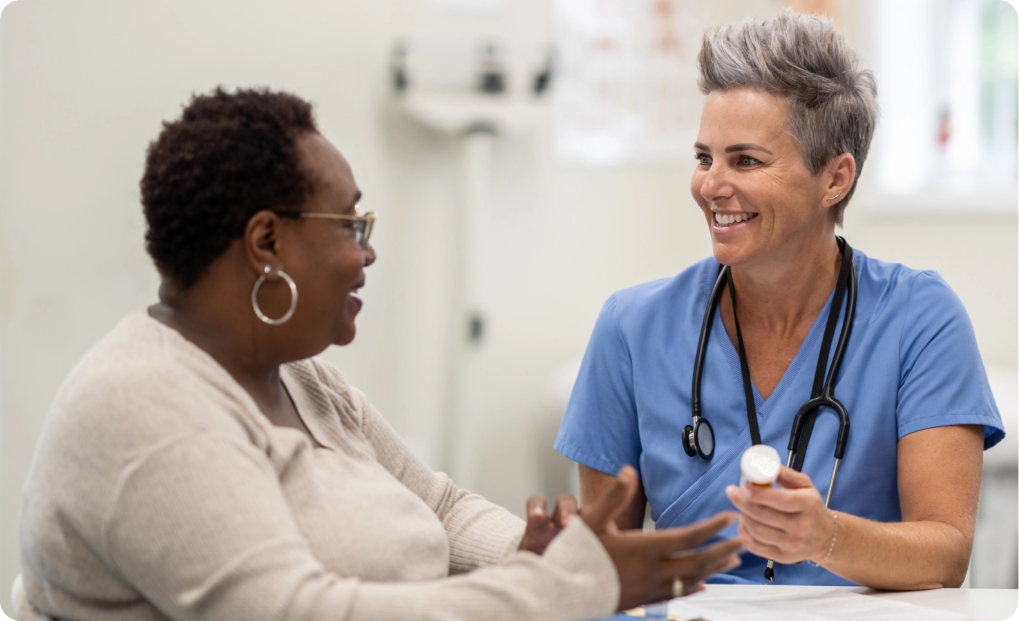 A female doctor consoles a patient on medication options