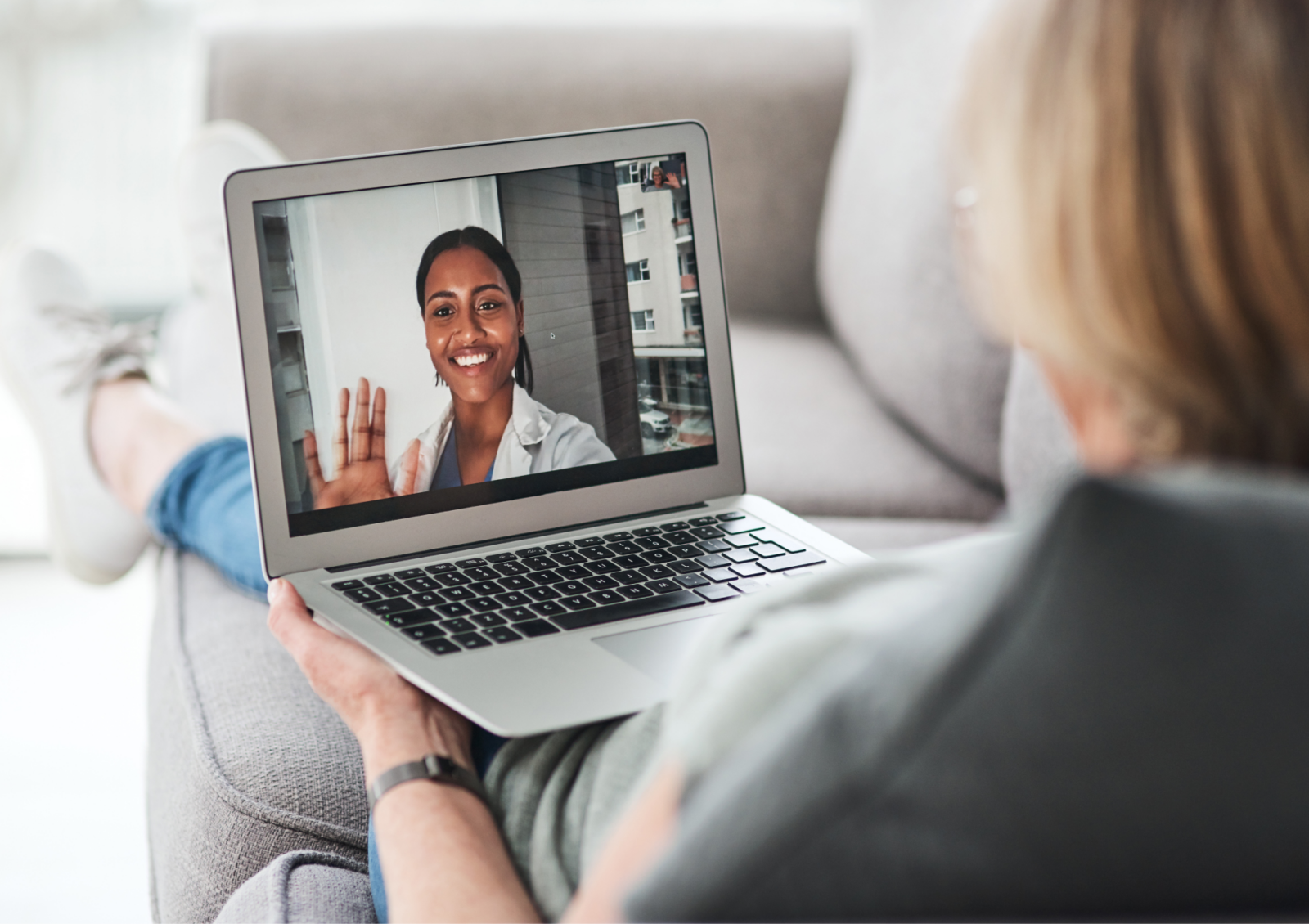 Woman on primary care visit on her computer.
