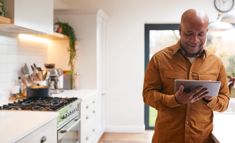 man-on-tablet-kitchen