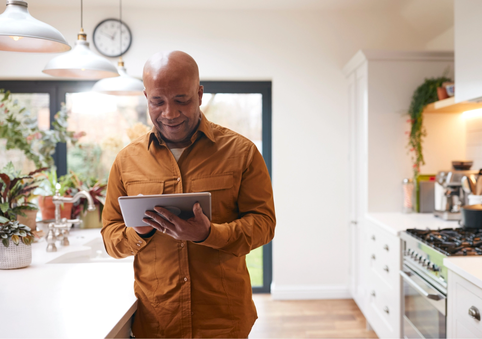 man using Included Health on ipad in kitchen