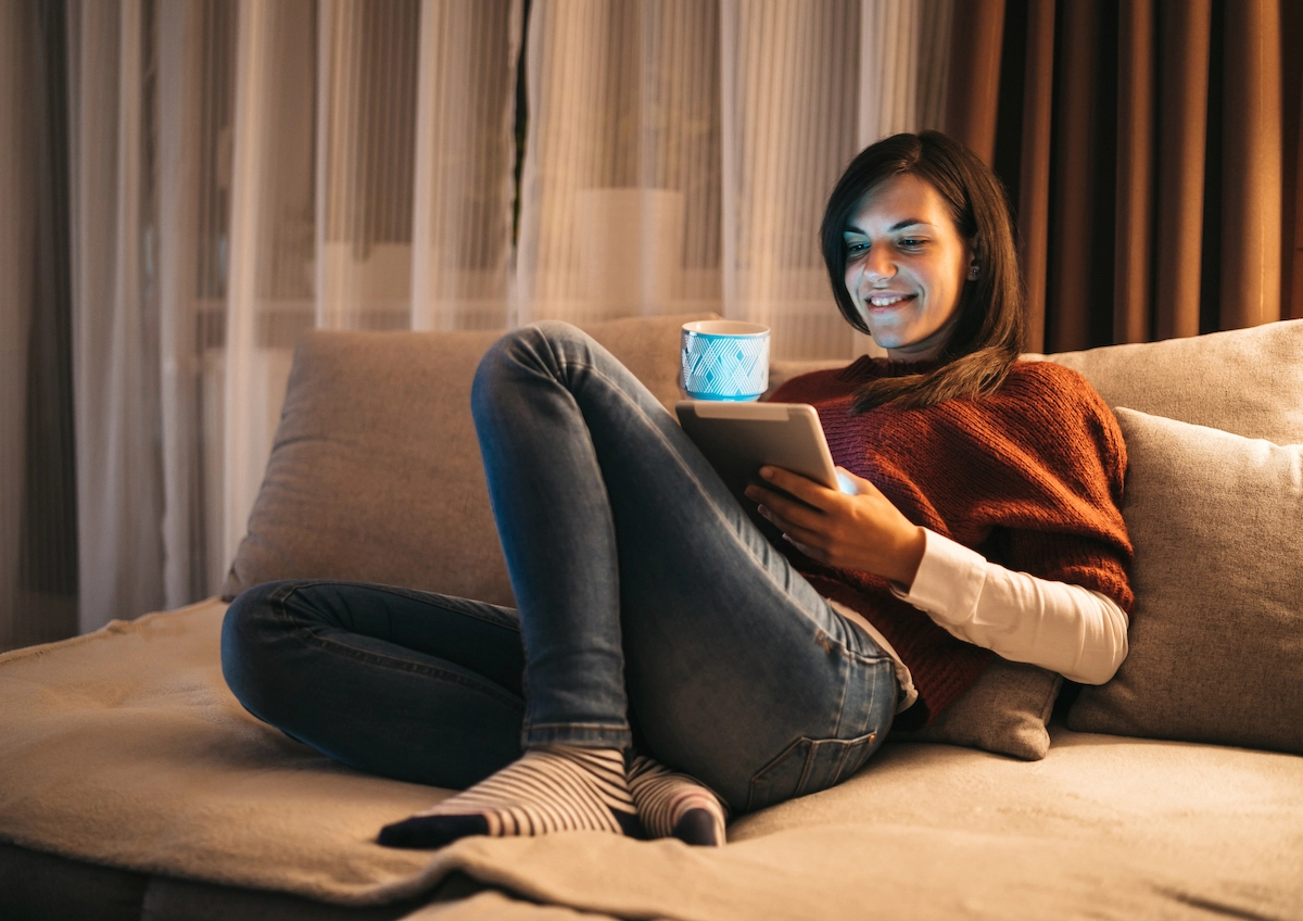 woman on couch with tablet