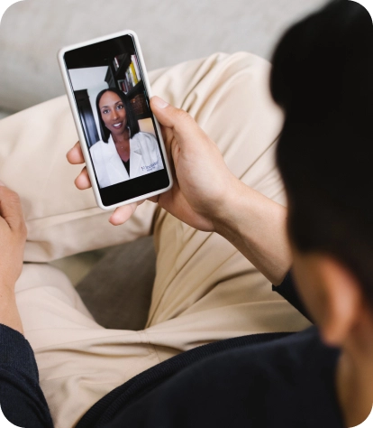 man on phone using Included Health app