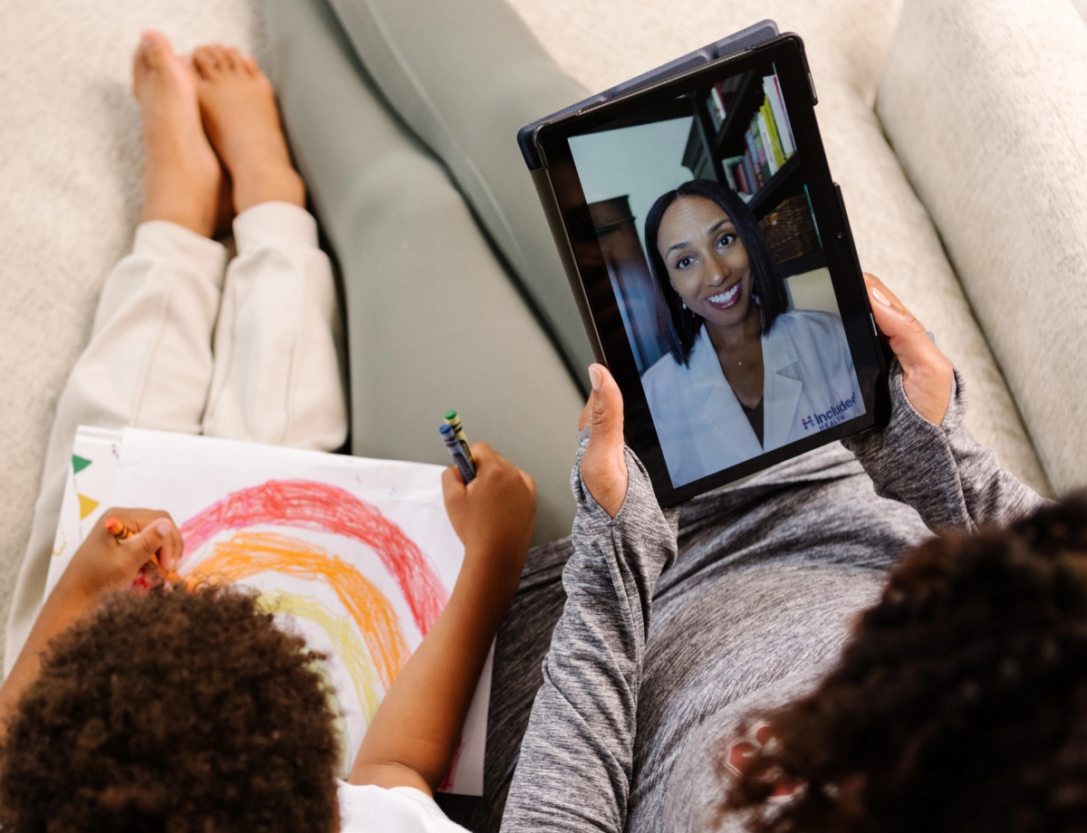 people on sofa with tablet