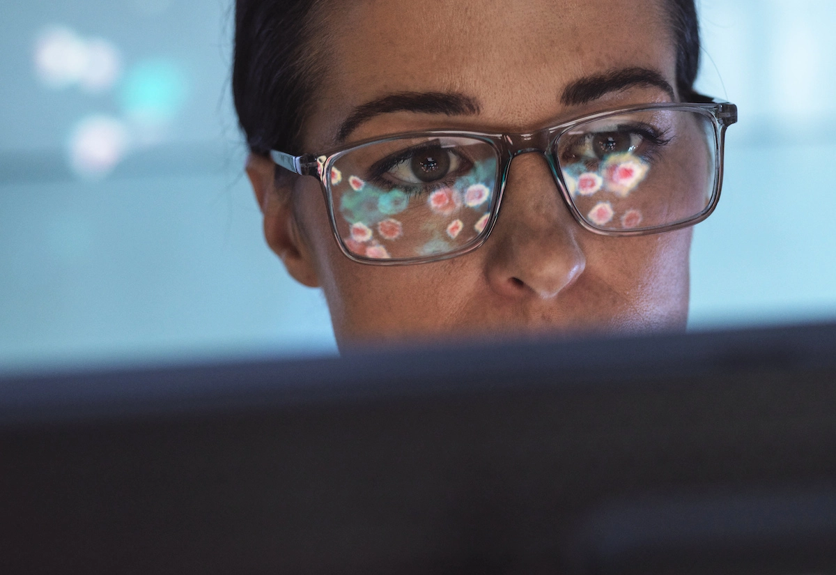 woman in tech looking at computer screen