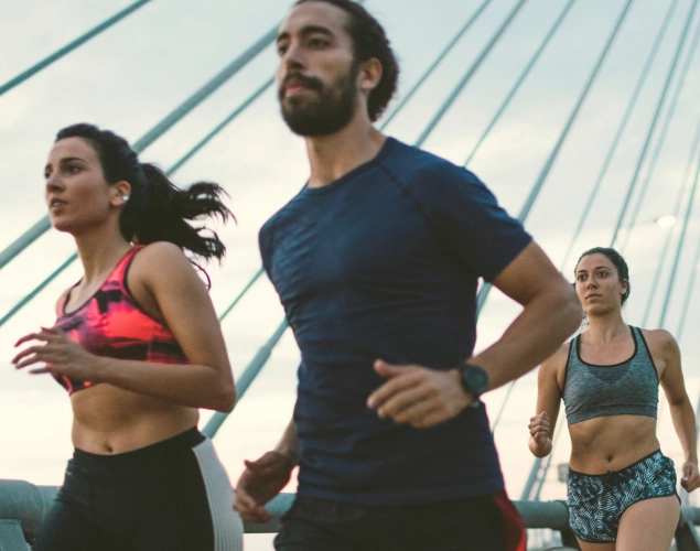 three people running together