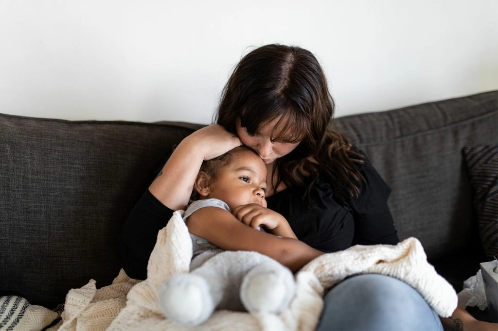 Mom on couch with sick child