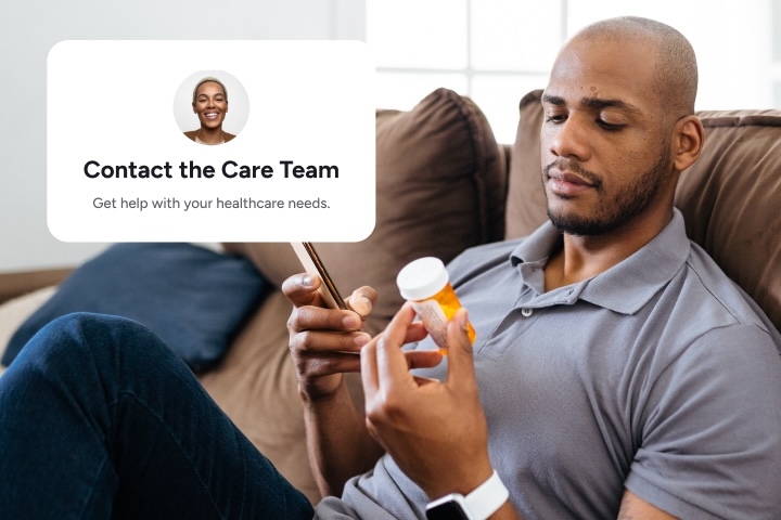 man sitting on couch looking at prescription