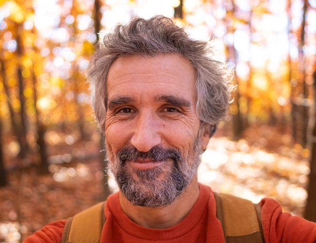 man smiling on hike