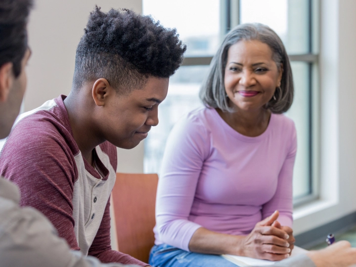 Family sitting with teen in a therapy session.