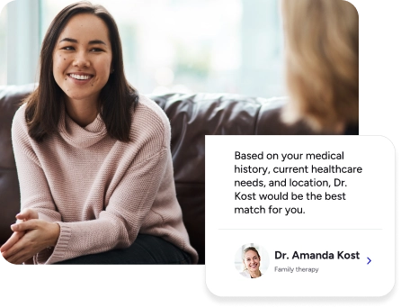 Woman sitting at therapy session smiling.