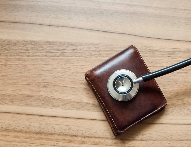 stethoscope on top of wallet on desk.