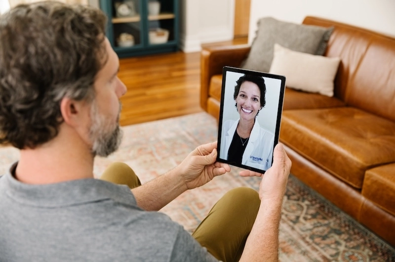 Included Health member talking to virtual care doctor on tablet.