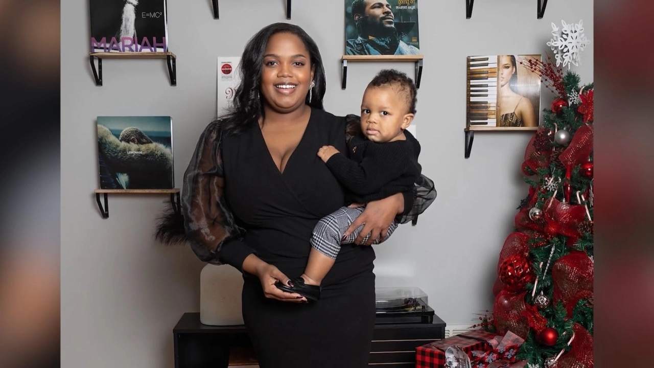 Rachell Dumas, MSN, RN is a Nurse Care Manager at Included Health seen holding her child.