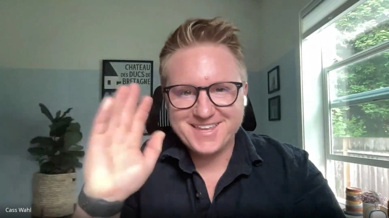 Cass waving to camera sharing their LGBTQ+ story